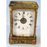 A 19thC gilt metal carriage clock, the 6cm enamel dial, set with Roman numerals with clover leaf