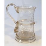 An unusual early 19thC glass tankard, the cylindrical part ribbed body with a strap scroll handle,