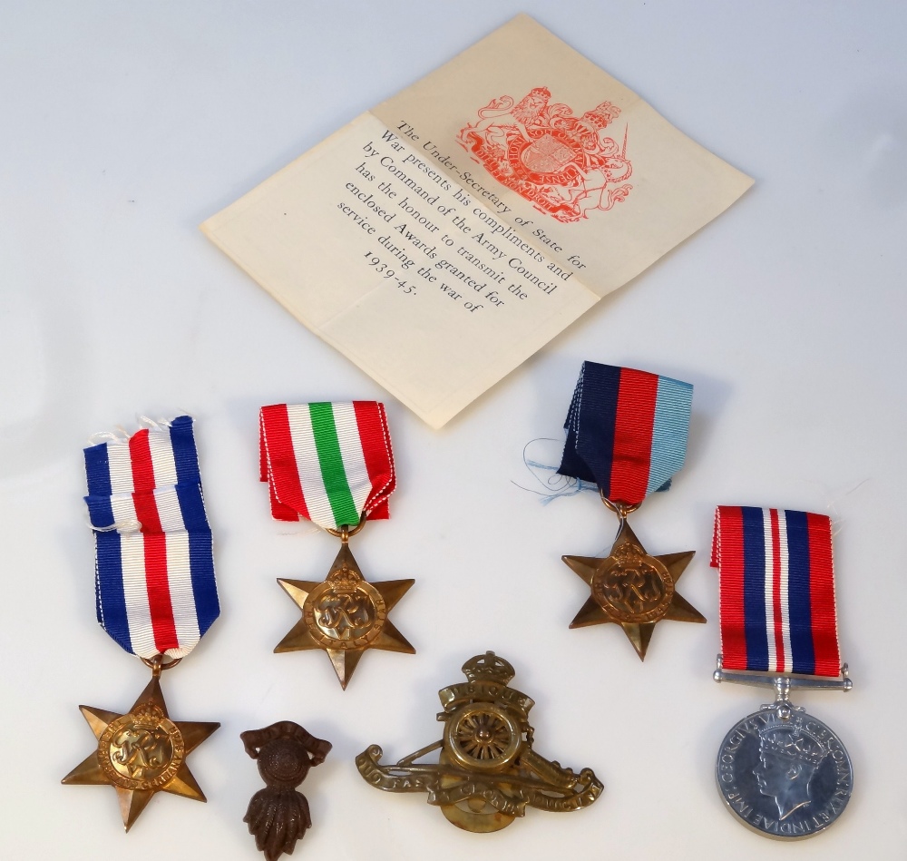 Various WWII medals, comprising three Stars, Campaign and two cap badges, in a box addressed to - Image 2 of 2