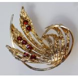 A leaf brooch, part pierced yellow metal with plain pin back, unmarked, 4cm wide.