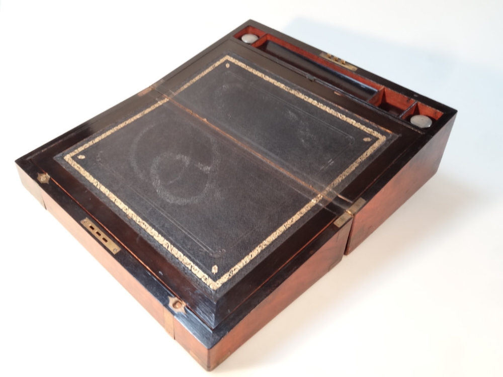 A 19thC brass bound writing slope, the rectangular lid hinging to reveal a part blue leather section