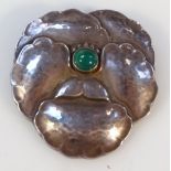 A Georg Jensen brooch, the shaped floral body part hammered, centred with a green agate polished