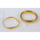 A 22ct gold circular wedding band, size N and another, 5.7g. (2)