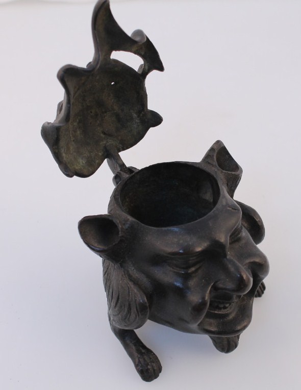 A late 19th/early 20thC bronze inkwell, in the form of a smiling satyr with hinged lid on triple - Image 2 of 3