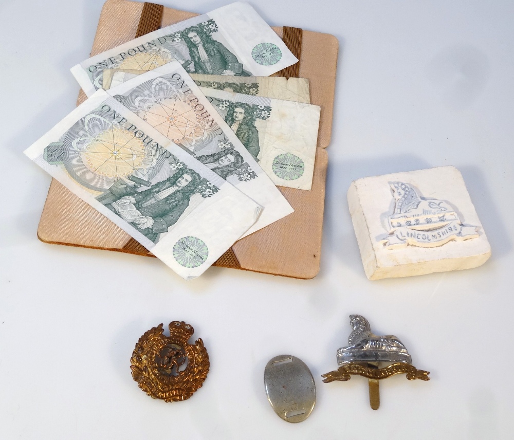 A Lincolnshire regimental cap badge, 7cm high, another, a Lincolnshire sphinx plaster cast block,