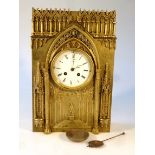 A 19thC gilt metal gothic style mantel clock, the 11cm dia. dial signed S. Wartinberg, with Roman
