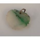 A Chinese pale and green fused jade pendant, the oval body with a plain ring end, 20thC, 2cm high,