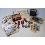 A set of World War II medals, associated ephemera, photographs, postcards, writings and clippings,