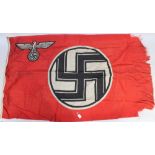 A Nazi Party Third Reich flag, rectangular cloth with imperial eagle and swastika on red ground,