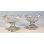 A pair of early 19thC cut glass salts, each fluted boat shaped bowl raised on a diamond shaped foot,