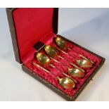 A set of six teaspoons, in the manner of Christofle, with shaped handles, yellow metal marked 18,