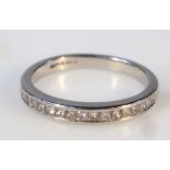 A ladies platinum and diamond half eternity ring, on a plain circular shank, size L, 3.6g all in.