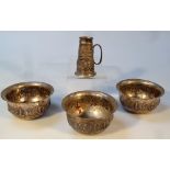 Three early 20thC Indian white metal bowls, each circular body raised with various figures on a