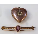 An early 20thC heart shaped pendant, set with small seed pearls, 3cm high, and a bar brooch, the