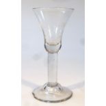 A late 18thC ale glass, the plain bell shaped bowl raised above a plain stem on a domed foot, 18cm