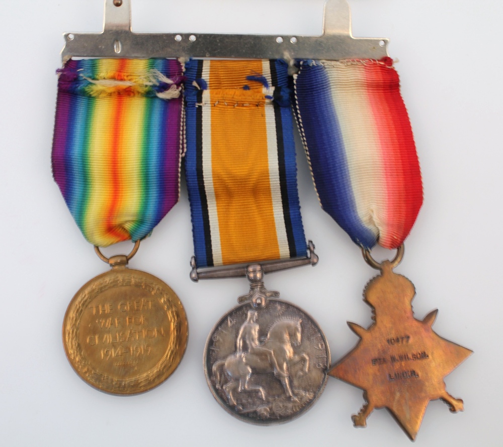 A WWI medal trio, comprising 1914-1915 Star, Campaign medal and Victory medal, awarded to 10477 PTE. - Image 2 of 2
