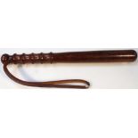 An early 20thC hardwood truncheon, with shaped end and turned handle with knop pommel and leather