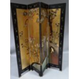 A 20thC Chinese lacquer finish four fold dressing or dividing screen, the sections with a continuous