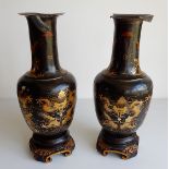 A pair of 19thC Chinese papier mache and black lacquered baluster vases, painted in gilt with dragon