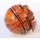 A most unusual polished treen puzzle ball, the orb cut into several pieces creating a 3D jigsaw when