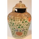 A Chinese porcelain Ming vase, with domed cover, polychrome decorated with flowers predominantly
