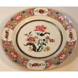 An early 19thC Japanese famille rose plate, the circular outline set with a floral banding,