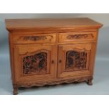 An hardwood Chinese design side cabinet, with over hanging rounded top above two short drawers and