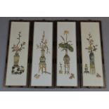 A set of four 20thC Japanese panels, each profusely engraved with vases of entwined flowers on a