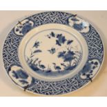 A blue and white porcelain plate, the centre decorated with birds and flowers with an outer