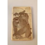 A Japanese Meiji period ivory card case, the rectangular rounded body etched with monkeys there