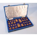 An Indian sandalwood chess set, the pieces carved as figures on the backs of elephants, camels and