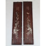 A pair of Japanese hardwood and mother of pearl finish panels, each set with seven character marks