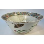 A Chinese porcelain punch bowl, the shaped circular body heavily polychrome decorated with exotic