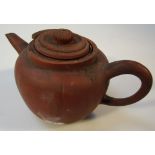 An 18thC Chinese Yixing red ware pottery teapot, the bulbous body of part ribbed form with a 'C'