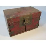 A late Japanese Meiji period red lacquered jewellery casket, the rectangular lid with a heavy