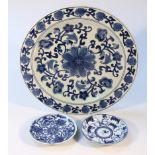 A 20thC earthenware blue and white plate, centred by a flower with further floral banding, 37cm dia.