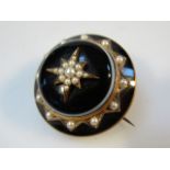 A Victorian memorial brooch, with window verso, bulls eye agate to the front with seed pearl set