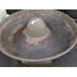 An 20thC Mexican hat, with cast metal pig trough on a stepped square base, 60cm high.