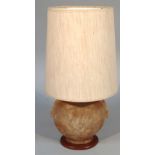 A 20thC lamp, the base possibly a bladder with wooden mounts and herringbone shaped shade, 64cm