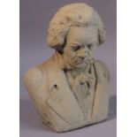 A 20thC stone bust of Ludwig Van Beethoven, quarter profile in typical pose with head down, unsigned