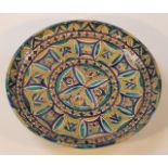 An 18thC faience charger, the circular body profusely decorated with a floral geometric pattern