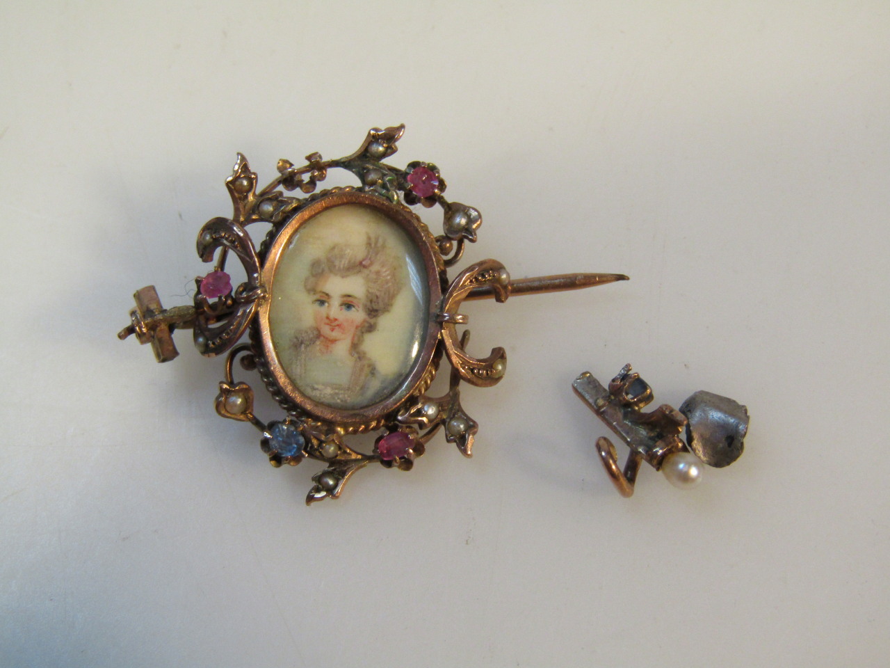 A late Victorian pendant brooch, centred with a profile of a lady with open plain pin back, a