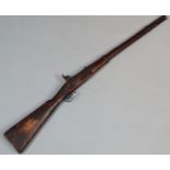 A 19thC percussion rifle, with metal mounts and trigger indistinctly stamped, 114cm wide. (AF)