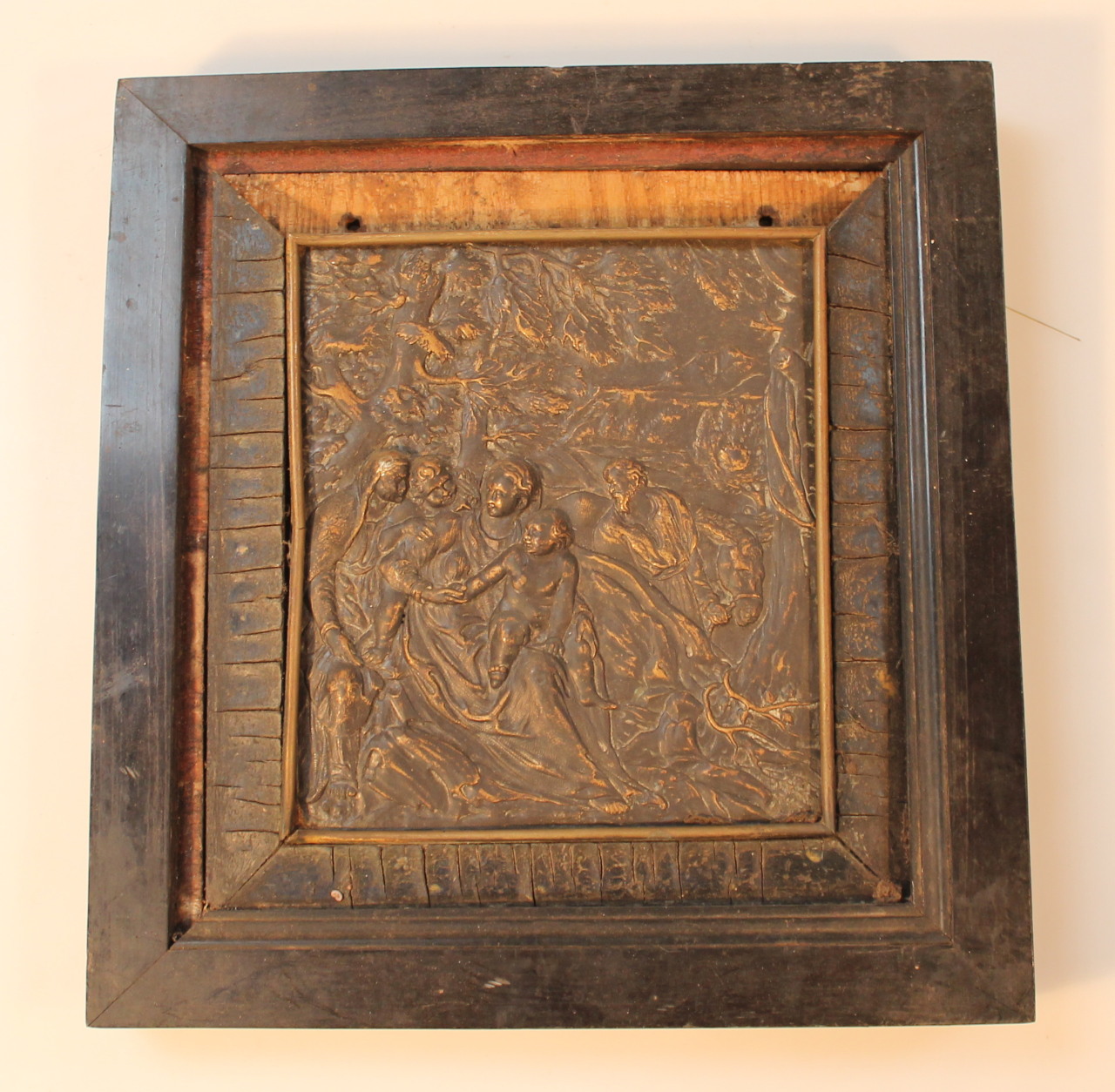 A 19thC cast metal relief plaque, raised with various semi clad figures before a bearded gentleman