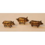 Three various early 20thC brass novelty vesta cases, in the form of pigs with articulated heads