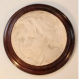 A 19thC relief plaster plaque, the circular body raised with a profile of a boy head only, 25cm dia,