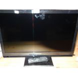 A Panasonic 23 inch colour television, with black surround and a small quantity of accessories.