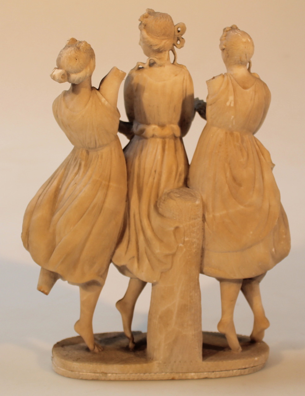 A 19thC alabaster figure group, of The Three Graces, each standing in flowing robes before tree - Image 2 of 3