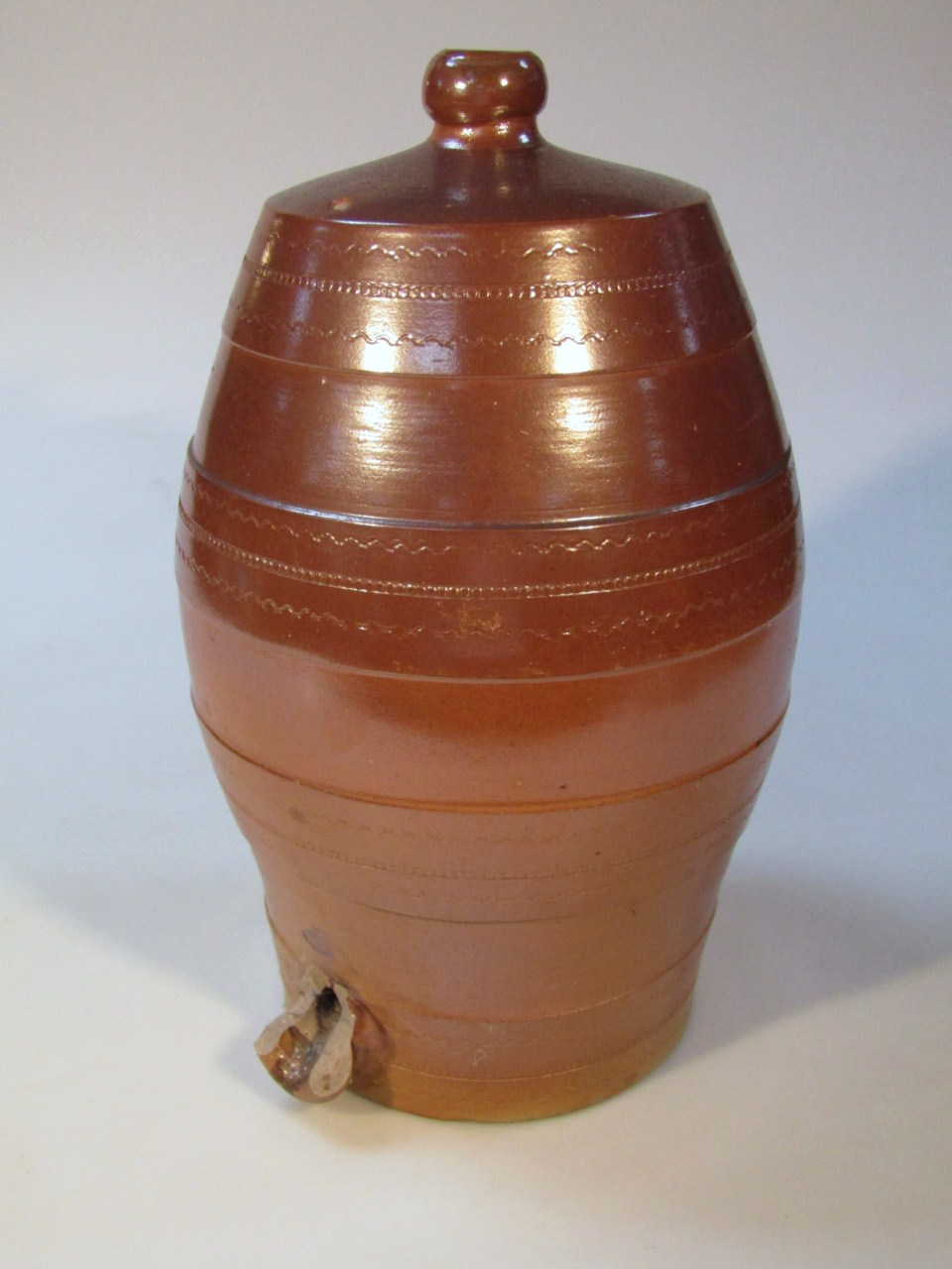 An early 20thC stoneware barrel, the bellied body with a light geometric banding with an upper