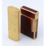 A 20thC Dupont cigarette lighter, the shaped rectangular body with a hinged lid, decorated in a